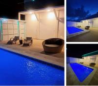 two pictures of a swimming pool with blue lights at Pousada QUERÊNCIA FRANCÊS in Marechal Deodoro