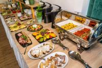 a buffet with many different types of food on a table at Malachit Karpacz SPA Hotel in Karpacz