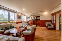 a living room with couches and a table at Malachit Karpacz SPA Hotel in Karpacz