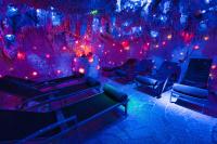 a room with red and blue lights and chairs at Malachit Karpacz SPA Hotel in Karpacz