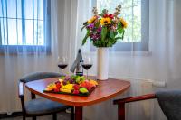 a table with a plate of fruit and two glasses of wine at Malachit Karpacz SPA Hotel in Karpacz