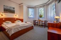 a bedroom with a bed and a table and chairs at Malachit Karpacz SPA Hotel in Karpacz