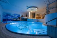 a hot tub on a cruise ship at night at Malachit Karpacz SPA Hotel in Karpacz
