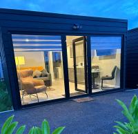 a room with sliding glass doors and a living room at The Tollstone in Duleek