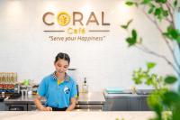 Una mujer parada en una cocina preparando comida. en Krabi SeaBass Hotel, en Krabi