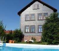 a house with a swimming pool in front of it at Alte Schule in Tambach-Dietharz