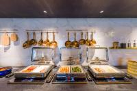 a kitchen with four trays of food on a counter at CitiGO Hotel Yuexiu Ouzhuang MTR Station Ghuangzhou - Free shuttle between hotel and Exhibition Center during Canton Fair in Guangzhou