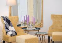 a living room with a table with purple candles on it at Villa Gutenberg Le Grand ---Free Parking--- in Klagenfurt