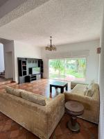 a large living room with a couch and a table at Villa Vue sur la Méditerranée in Cabo Negro