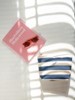 a pair of sunglasses sitting next to a pack of towels at Hotel OFF Paris Seine in Paris