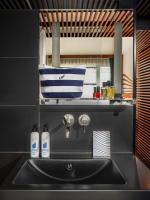 a kitchen sink with two bottles on a shelf above it at Hotel OFF Paris Seine in Paris