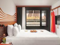 a bedroom with a white bed with a window at Hotel OFF Paris Seine in Paris