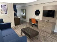 a living room with a couch and a desk with a tv at Holiday Inn Express Hotel & Suites San Dimas by IHG in San Dimas