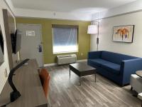 a living room with a blue couch and a table at Holiday Inn Express Hotel & Suites San Dimas by IHG in San Dimas
