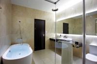 a bathroom with a tub and a sink at Airline Inn Green Park Way in Taichung