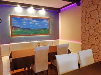 a dining room with a table and white chairs at Pensjonat Zielone Wzgórze w Bolesławowie in Stronie Śląskie