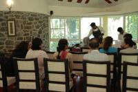 un grupo de personas sentadas en sillas en un restaurante en Kairali - The Ayurvedic Healing Village, en Palakkad