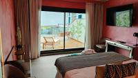 a bedroom with a bed and a view of a balcony at Hotel Ritual Torremolinos- Adults Only in Torremolinos
