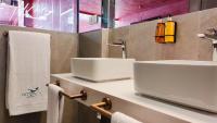 a bathroom with two sinks and towels on a counter at Hotel Ritual Torremolinos- Adults Only in Torremolinos