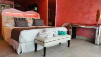 a bedroom with a bed and a chair with towels at Hotel Ritual Torremolinos- Adults Only in Torremolinos