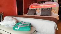 a bedroom with two beds and a green towel at Hotel Ritual Torremolinos- Adults Only in Torremolinos