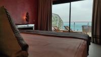 a bedroom with a bed with a view of the ocean at Hotel Ritual Torremolinos- Adults Only in Torremolinos