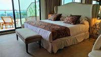 a bedroom with a bed and a chair and a window at Hotel Ritual Torremolinos- Adults Only in Torremolinos