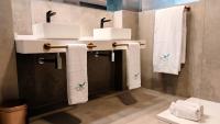 a bathroom with two sinks and towels on a wall at Hotel Ritual Torremolinos- Adults Only in Torremolinos