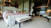 a bedroom with a large bed and a chair at Hotel Ritual Torremolinos- Adults Only in Torremolinos
