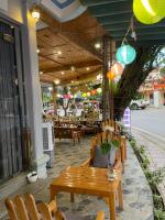 a wooden bench sitting in front of a restaurant at Vi TamCoc Hotel in Ninh Binh