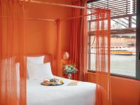 a bedroom with a bed with a plate of food on it at Hotel OFF Paris Seine in Paris