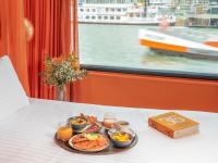 a tray of food on a table with a plate of food at Hotel OFF Paris Seine in Paris