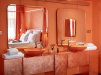 a bathroom with two sinks and a large mirror at Hotel OFF Paris Seine in Paris