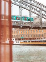 a train on a bridge over the water at Hotel OFF Paris Seine in Paris