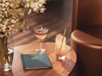a table with a glass of wine and a drink at Hotel OFF Paris Seine in Paris