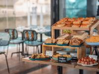a display case with different types of bread and pastries at Hotel OFF Paris Seine in Paris