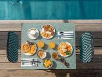 a table with plates of breakfast food on it at Hotel OFF Paris Seine in Paris