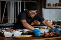グアダラハラにあるHilton Guadalajara Midtownの食卓の上で料理する男