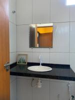 a bathroom with a sink and a mirror at Pousada QUERÊNCIA FRANCÊS in Marechal Deodoro