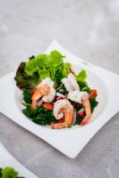 a white plate with a salad with shrimp on it at ชญาดา การ์เด้นเฮาส์ & รีสอร์ท Hotel in Nakhon Ratchasima