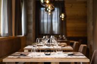 a row of wine glasses on a table in a restaurant at Hotel Laste' in Caldes
