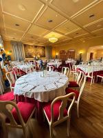 a banquet hall with white tables and chairs at Grand Hotel De Londres in Sanremo