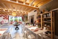 a dining room with white tables and chairs at Agriturismo Sadira in Calusco dʼAdda