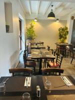 a dining room with tables and chairs and tables sidx sidx sidx at Au Relais Gascon in Labastide-dʼArmagnac