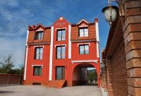 a red building with an archway in front of it at Schassburger Tor in Sighişoara
