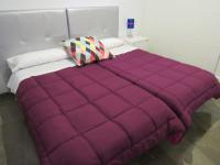A bed or beds in a room at Apartamentos Ilíberis