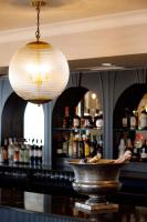 a bar with a counter with bottles of alcohol at The Albion in Freshwater