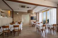 A television and/or entertainment centre at B&B HOTEL Diano Marina Palace