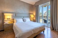 A bed or beds in a room at B&B HOTEL Diano Marina Palace