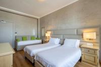 A bed or beds in a room at B&B HOTEL Diano Marina Palace